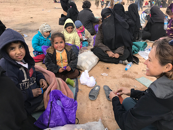 Playing with the children as they wait for a transport to the camps. 