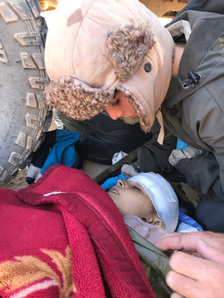 Pete prays with and comforts a boy who was shot in the head.