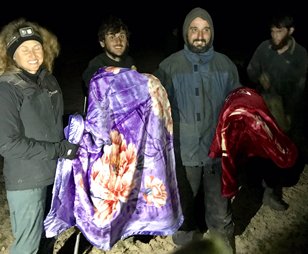 Karen gives blankets to men who recently fled ISIS stronghold.