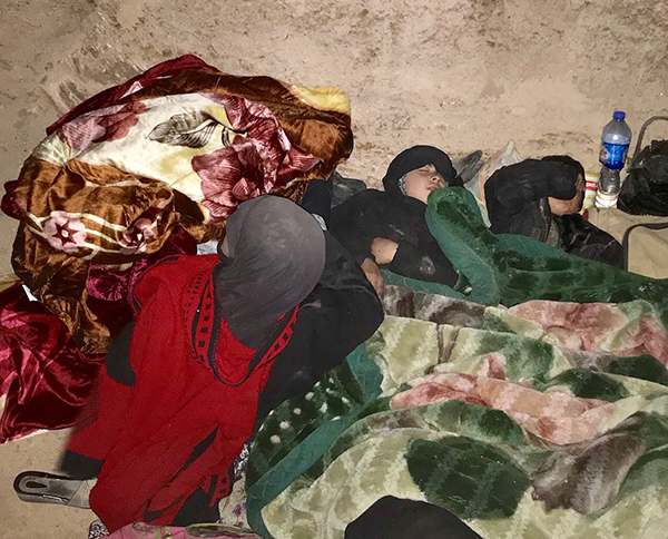 A family sleeping under their new blankets.