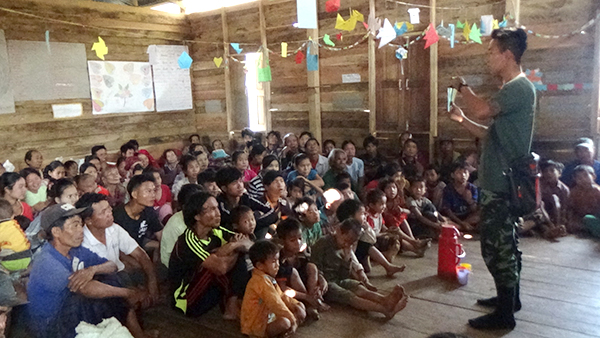 A ranger uses a wordless book to share about love during a GLC program.