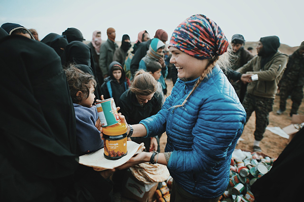 Sahale gives food to an ISIS wife and child after they fled Baghouz.