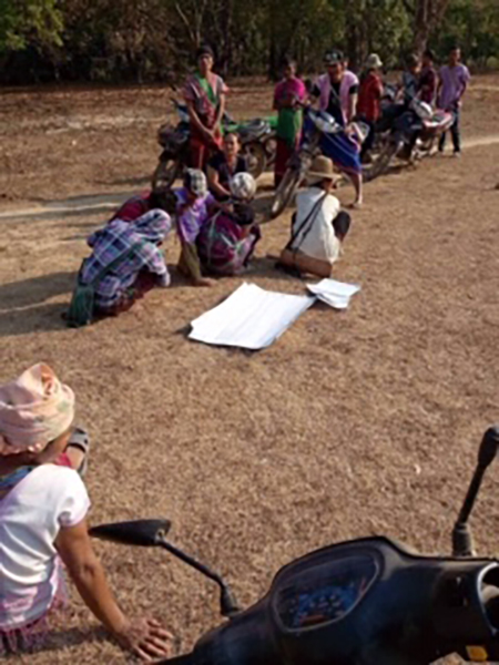 Villagers protesting the construction of the road and bridge.