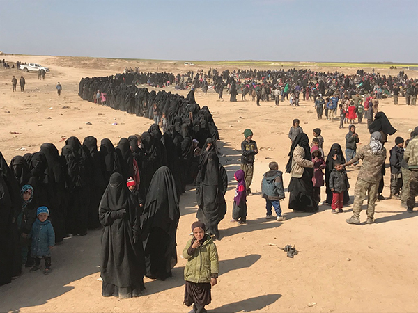 A line of ISIS families arriving after fleeing Baghouz.