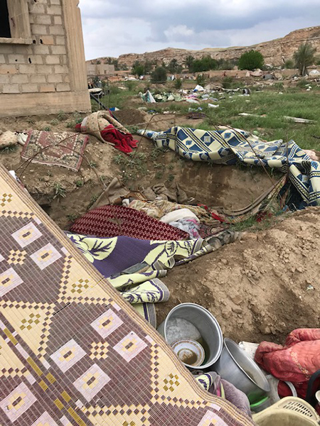 A hole where families hid in Baghouz.