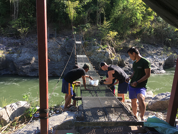 Working on the bridge after it broke during rainy season last year.