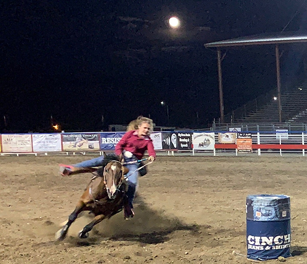 Suu barrel racing at the rodeo.