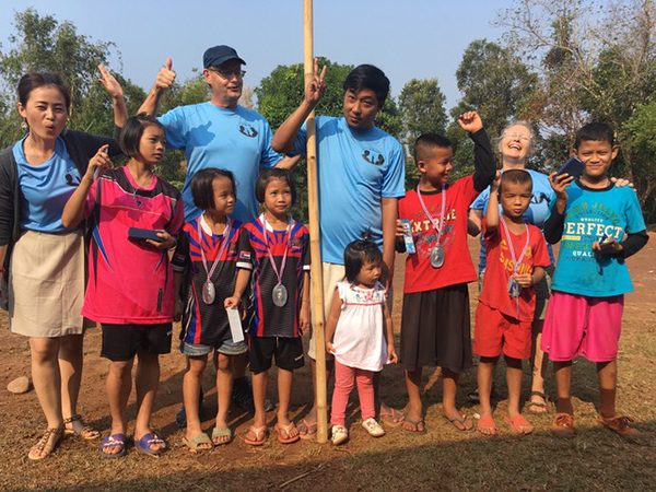 Eh Klo Moo, center, with the winners of the Run 4 Relief in Bueng Klueng.
