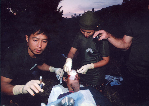 Eliya giving medical care to a Karen man while on mission. Eliya was the first Ranger.