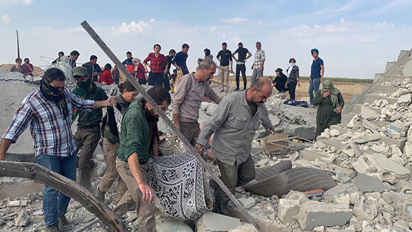 Digging out bodies from an Oct. 15 Turkish airstrike in Musherfa, south of Seri Kani