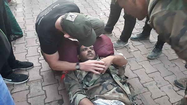 Praying with the wounded Syrian Army soldier before he was transported to Qamishli.