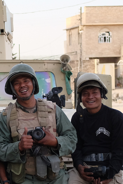 Zau, at left, pictured with fellow cameraman, Monkey, in Mosul, Iraq.