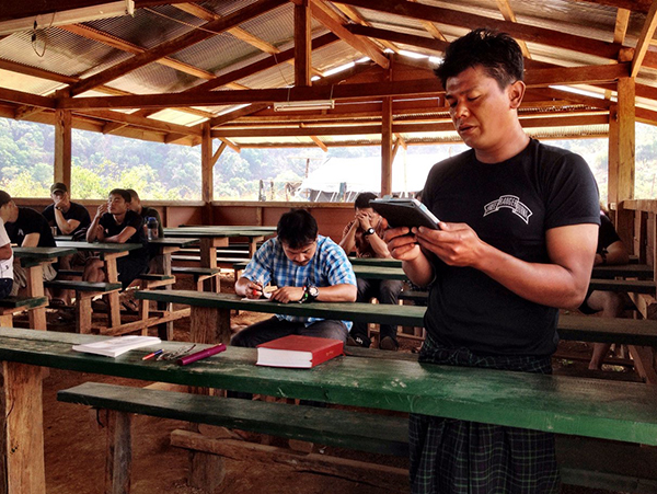 Zau Seng reading scripture during Tah U Wah training camp.