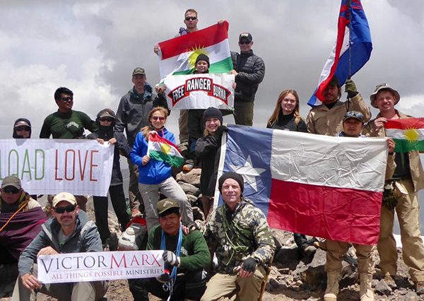 Zau Seng, in the back left corner, with the team on the highest mountain in Iraq