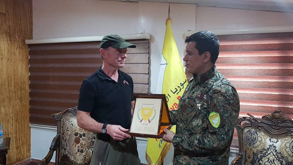 Receiving a plaque from Gen. Abdi.