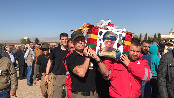 Carrying Zau's coffin in the procession.