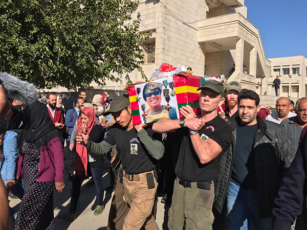 Dave and Joseph carry Zau Seng's coffin with the help of other teammates.