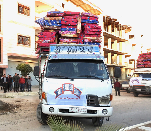 A truck full of mattresses for displaced families.