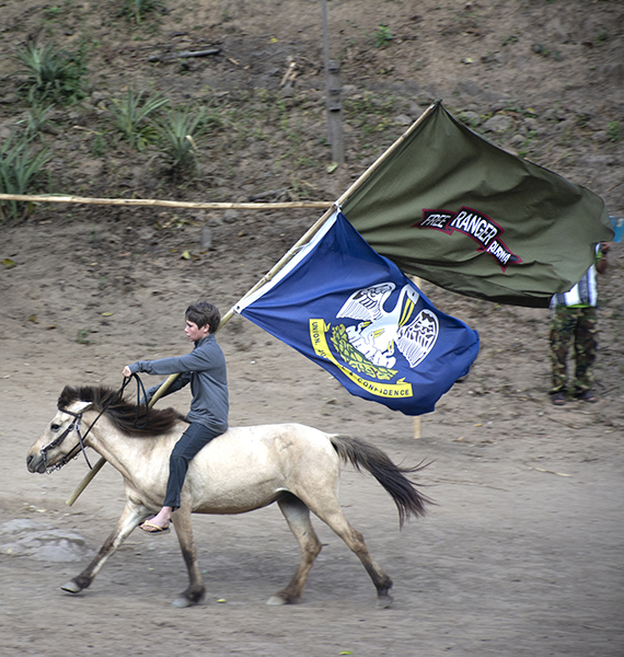 Peter Eubank helps open the ceremony by carrying in the FBR and Louisiana flags