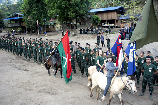 Peter, Suu, and Sahale Eubank open the graduation ceremonies by carrying in FBR, Louisiana, Karen, and Kachin flags