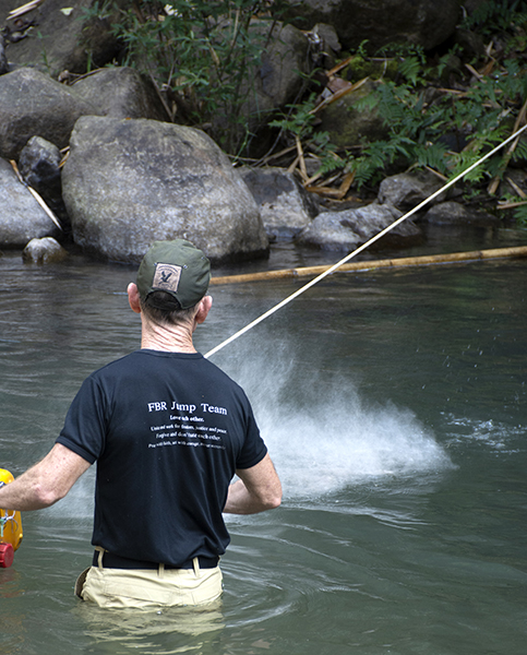 Scattering Zau's ashes into the camp river