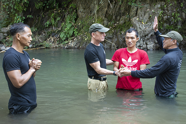 Dave Eubank and Pastor Edmond baptize Ray Khin, a medic from the Jungle School of Medicine-Kawthoolei