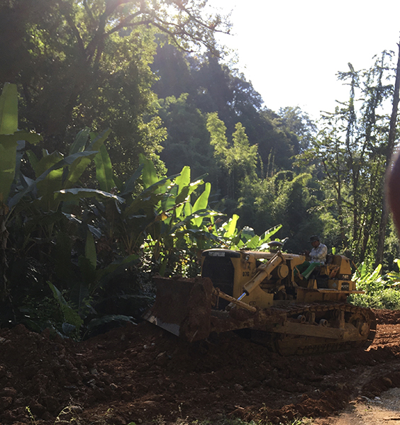 A Burma Army bulldozer working on the road.