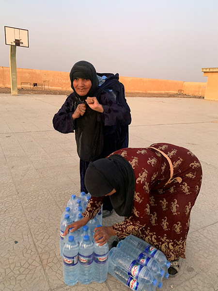 Families getting ready to head out with their water.