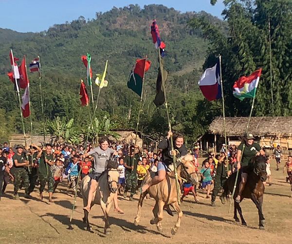 Running across the field. The Burma Army camp is on the mountain in the background.