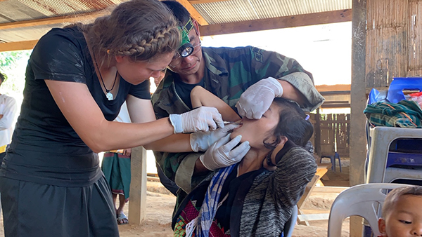 Sahale helping with dental care during the medical clinic