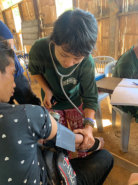 A medic checking a villager during the medical clinic