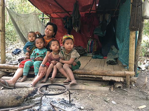 A family in their makeshift jungle living quarters