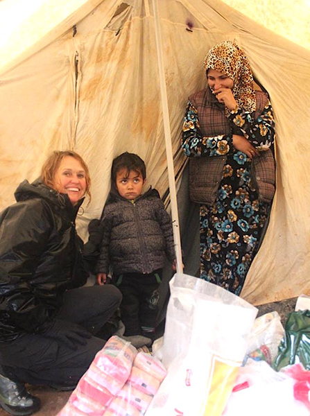 Karen with one of the families in their tent.