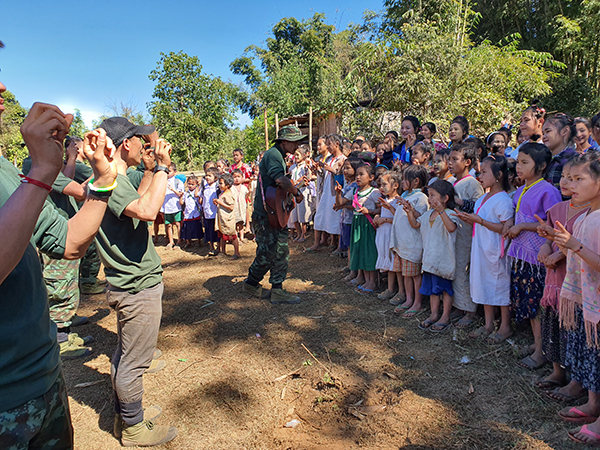 A Ranger leads the crowd in singing