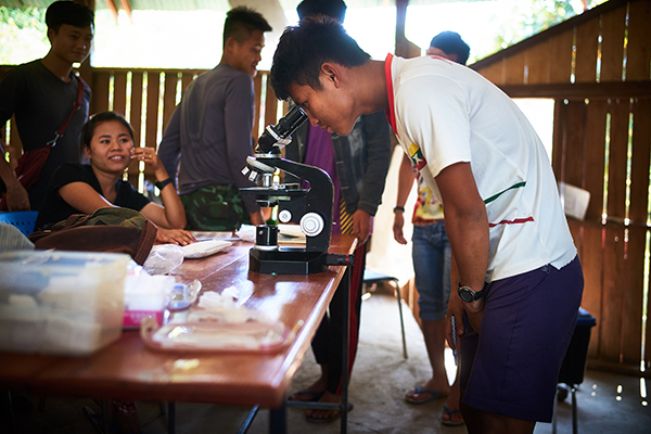 A student inspects a sample during class