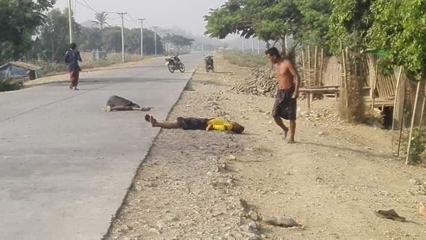 Locals inspect the scene after the attack in Arakan State