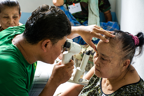 Nay Hser checks a Karen villager for possible cataracts.