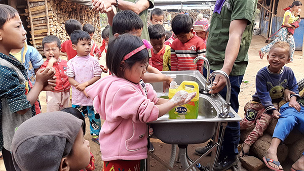 Children wash their hands after a lesson on good health and hygiene during a Good Life Club program.