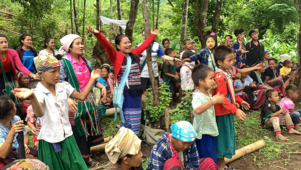 Singing together during a village program.