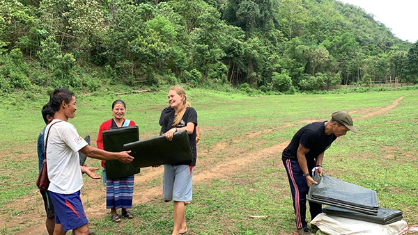 Sahale and Doh Say give out tarps to the displaced people of Lo Ko and Ler Mu Plaw villages.