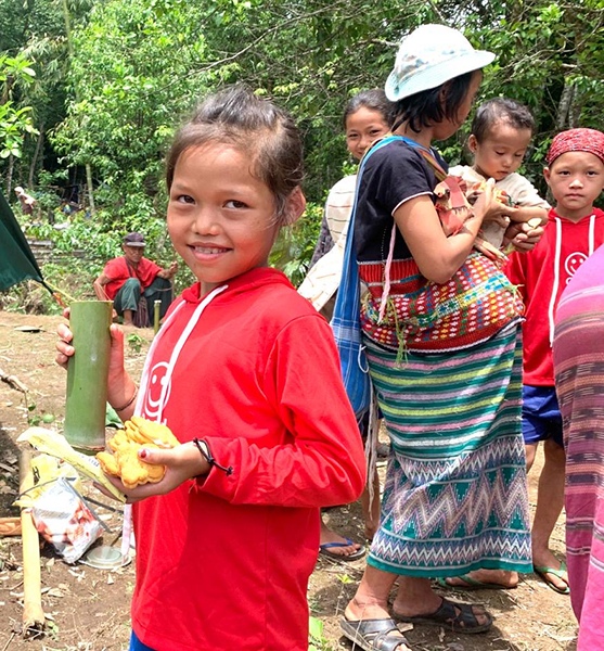 A child displaced by the Burma Army enjoys lunch during a Good Life Club program.