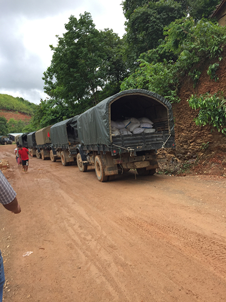 Burma Army trucks carrying rice between camps.