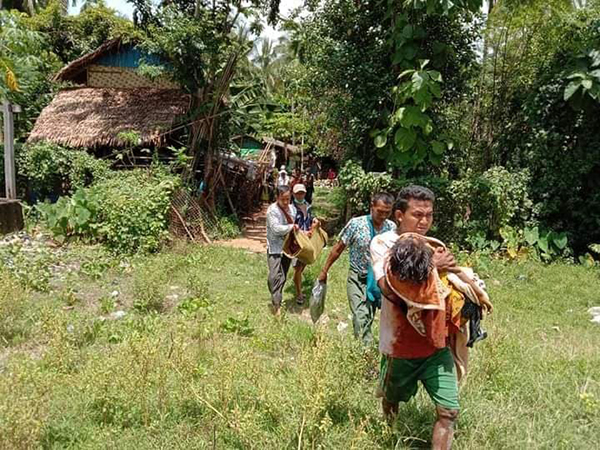 Villagers carry the victims of the attack