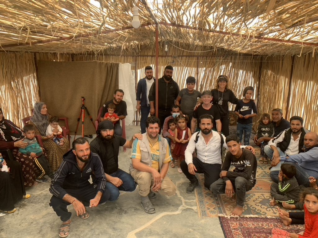 Hamdu, center, in white in tent church he started for IDPs in Washi Kani camp