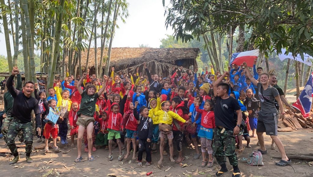 Displaced children and team members sing together