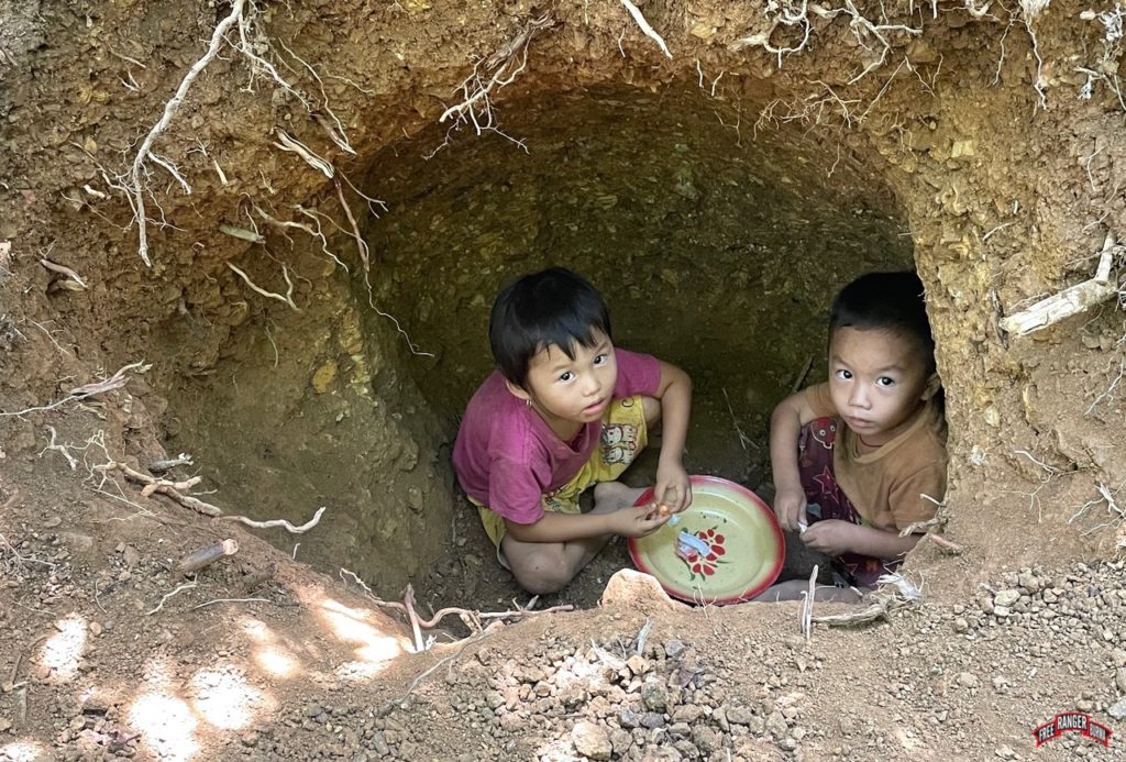 Children hiding in a hole from Burma Army